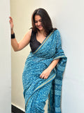 Woman wearing a blue saree with a white background